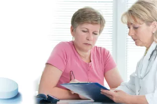 Woman having discussion with doctor